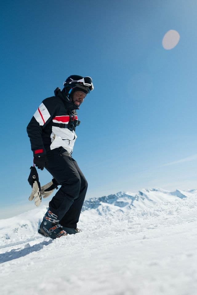 A skier catching air against a blue sky
